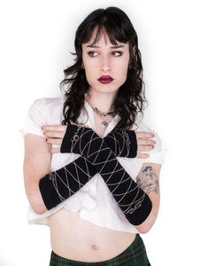 Photo showing model crossing arms while wearing gloves, looking longingly into the distance