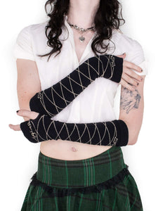 Photo showing black and cream sleeve gloves with lace up bow and cursive logo design