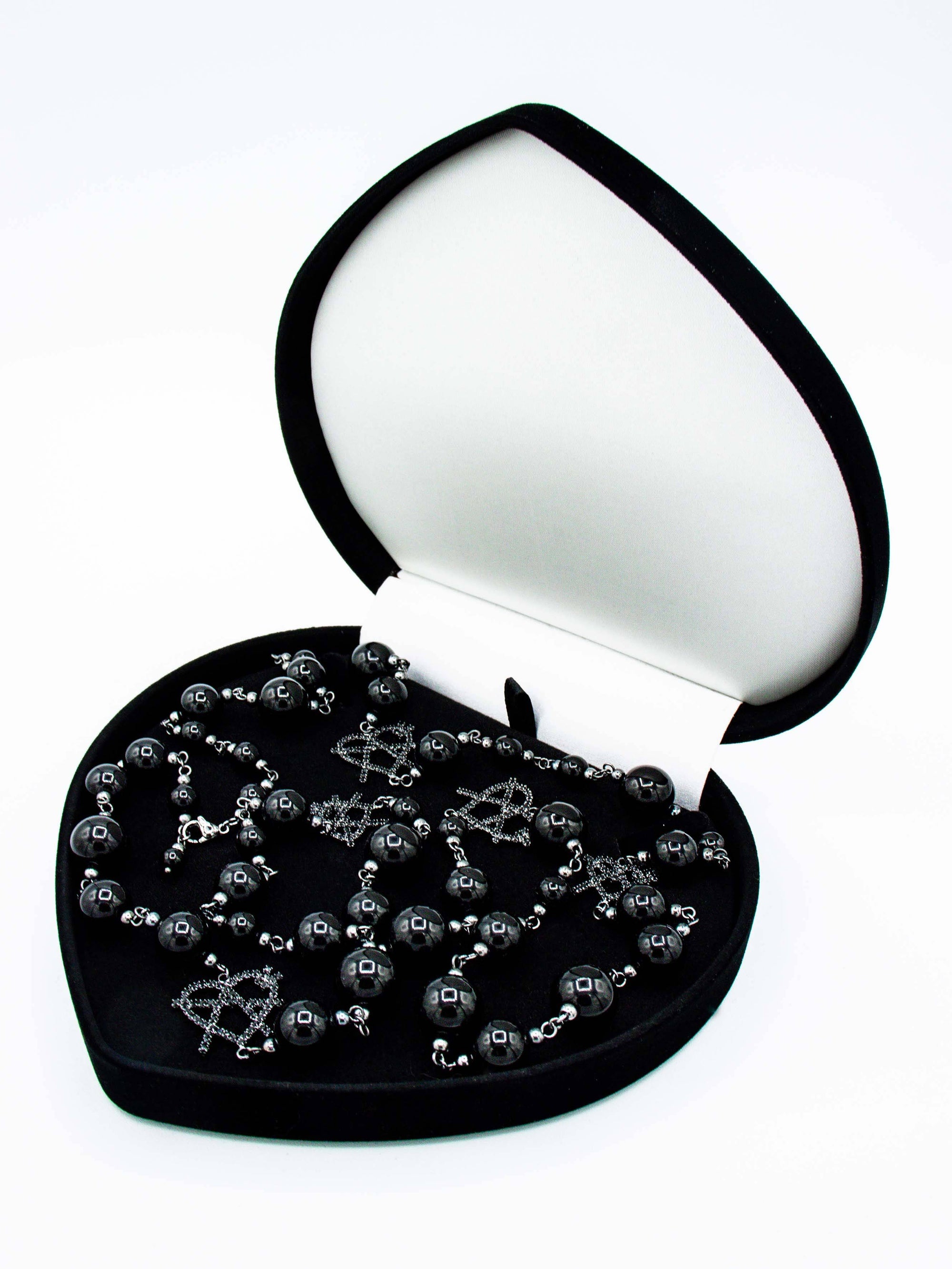 Black iGirl Pearls shown in black velvet box that the product comes in
